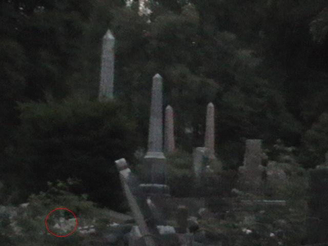 Ghostly head rising from grave